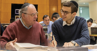 Grandfather and grandson studying together