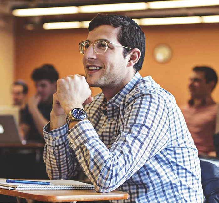 Smiling male Orthodox student in class