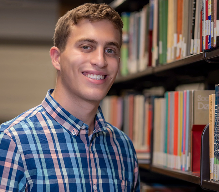 Smiling male Orthodox student in a library