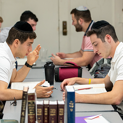Male orthodox student studying together