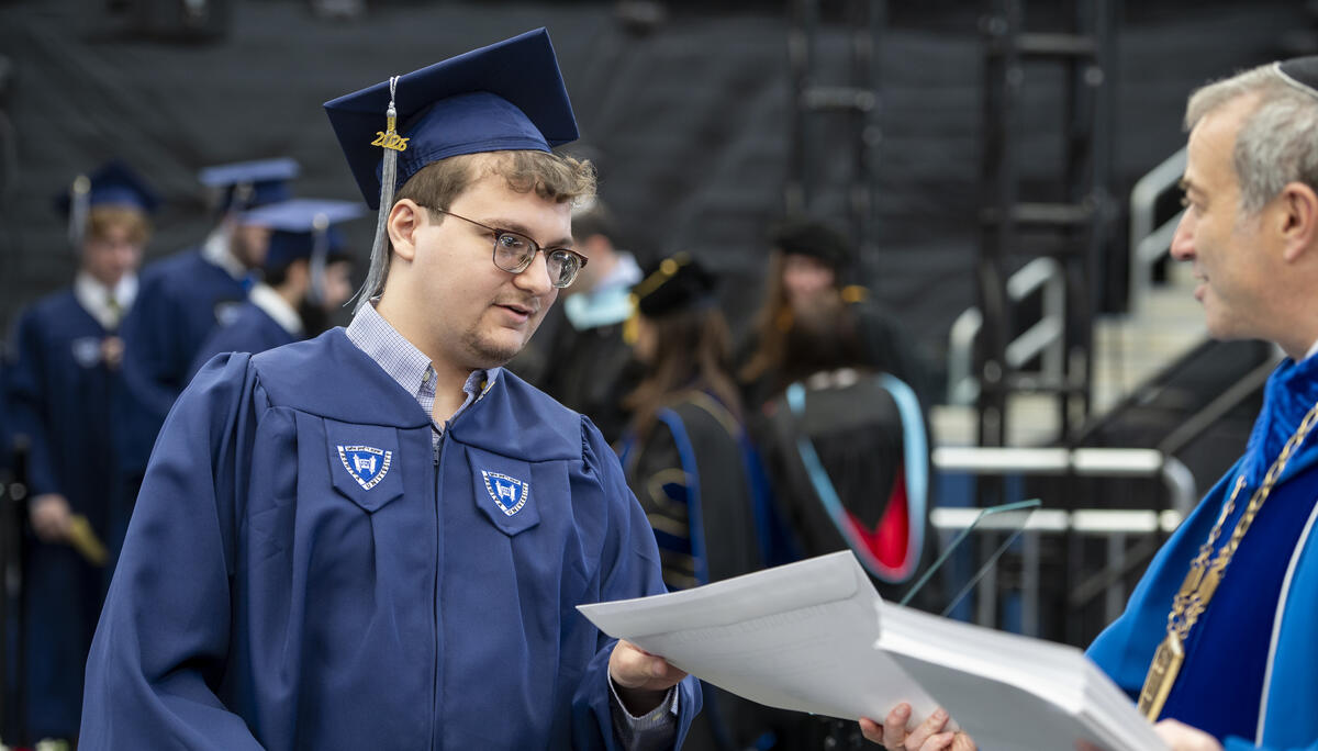 Samuel Halpern receives his diploma at Yeshiva University's 95th Annual Commencement.
