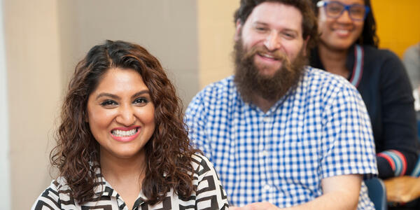 Graduate students smiling in class