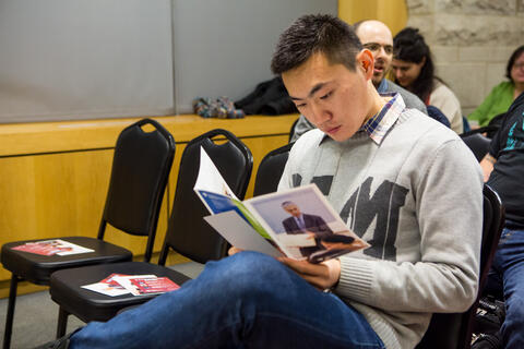 Audience member reading brochure