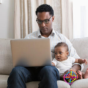 African American mal with laptop and toddler