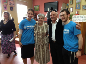 CJF-Rivka-Kaminetzky-and-Menachem-Leib-Brenner-join-a-group-of-seniors-for-a-pre-Shabbat-party-as-part-of-the-Migdal-Hesed-program