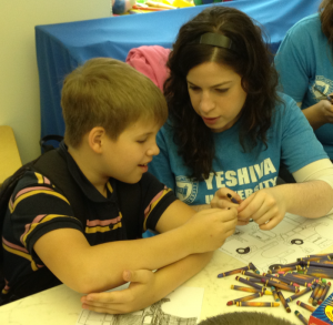 CJF-Yonina-Fogel-works-together-with-a-young-boy-on-an-art-project-at-Odessas-JCC-Beit-Grand