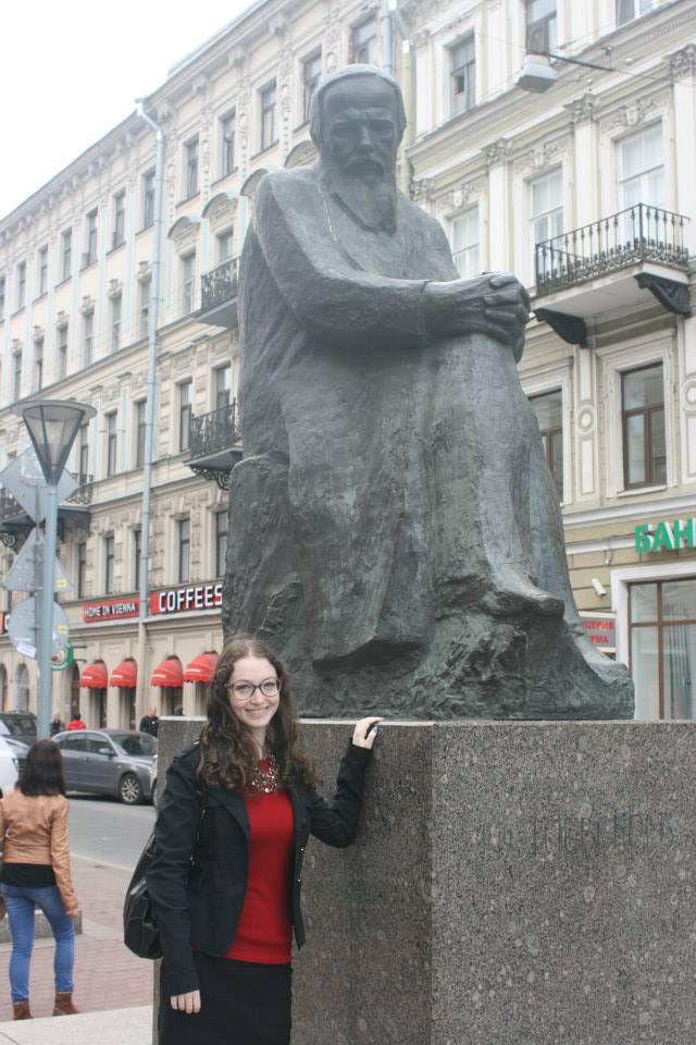 Hannah Rozenblat, a Stern College for Women alum who participated on the trip, with a statue of Fyodor Dostoevsky