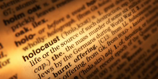 CLOSE UP OF DICTIONARY PAGE SHOWING DEFINITION OF THE WORD HOLOCAUST