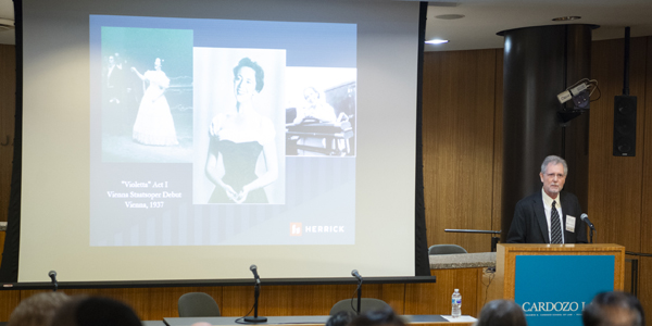 Spiegler at the lectern with slide show