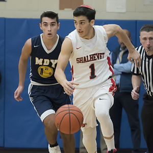 Two basketball players running down the court.