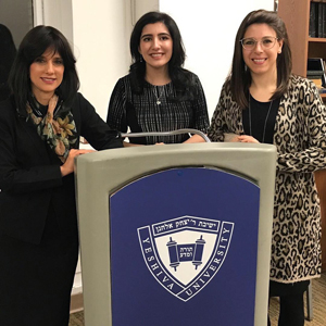 Photo of the three standing at a lectern