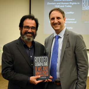 Dr. Ronnie Perelis and Dr. James Loeffler standing holding Dr. Loeffler's book