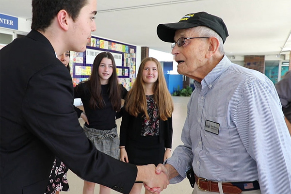 A young student interviews a survivor.