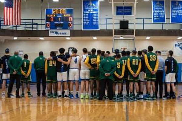 Basketball players from YU and NJCU have a moment of silence.