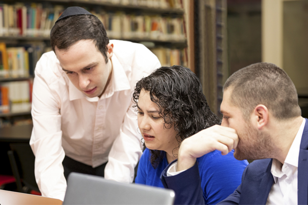 SGC Header image: three people looking at a computer